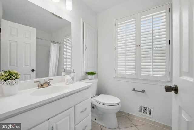 bathroom featuring tile patterned flooring, toilet, vanity, curtained shower, and baseboards