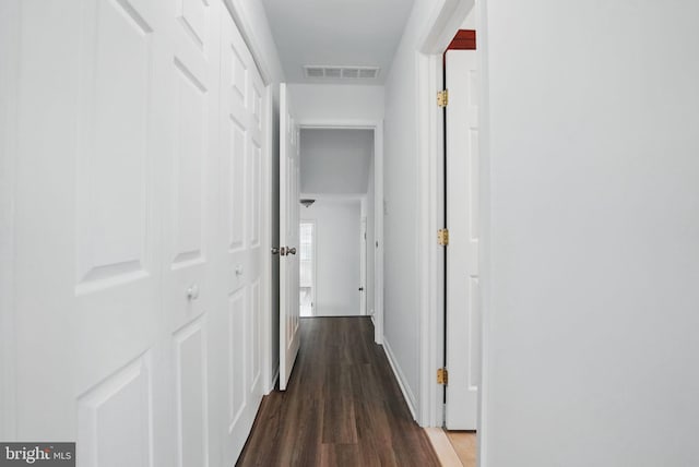 hall featuring dark wood-style floors and baseboards