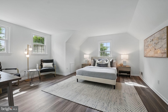 bedroom with dark wood-type flooring, lofted ceiling, and baseboards