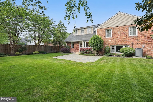 back of house featuring cooling unit, a patio, and brick siding