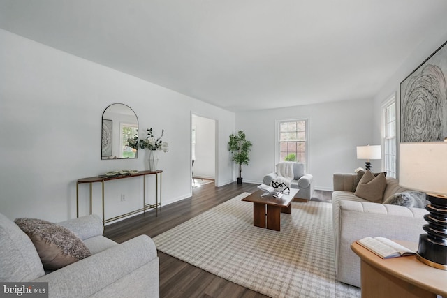 living area with dark wood-style floors and baseboards