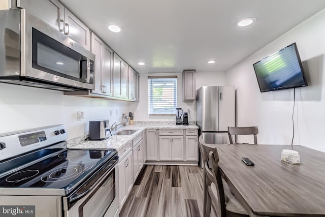 6328 Martin Luther King Jr Hwy, Capitol Heights, MD 20743 - kitchen with stainless steel appliances, a sink, light stone counters, dark wood-type flooring, and recessed lighting