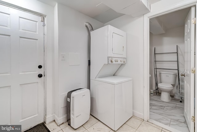 6328 Martin Luther King Jr Hwy, Capitol Heights, MD 20743 - laundry room featuring estacked washer and dryer, light marble finish floors, and baseboards