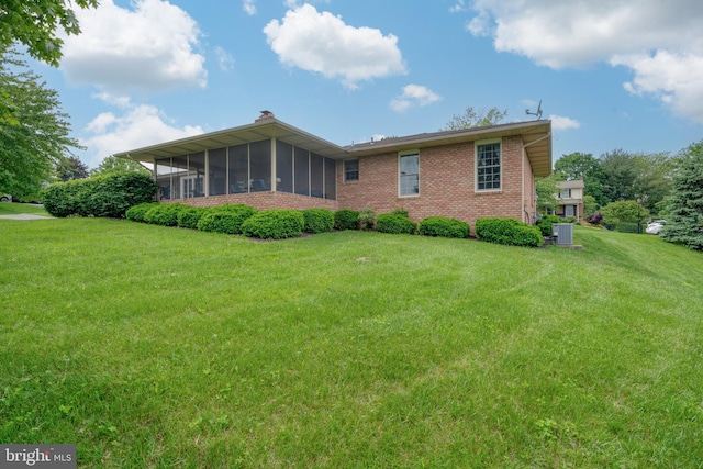 3731 Long Point Dr, York, PA 17402 - back of house featuring a sunroom, brick siding, a yard, cooling unit, and a chimney