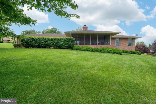 3731 Long Point Dr, York, PA 17402 - back of property featuring a chimney, a yard, a sunroom, and brick siding
