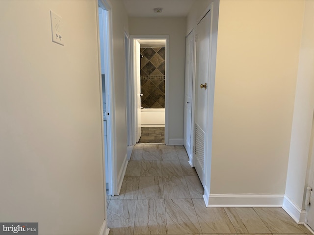 hallway featuring baseboards
