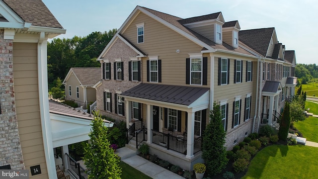 16 Magpie Ln, Princeton Junction, NJ 08550 - rear view of house featuring covered porch, brick siding, a standing seam roof, and a metal roof