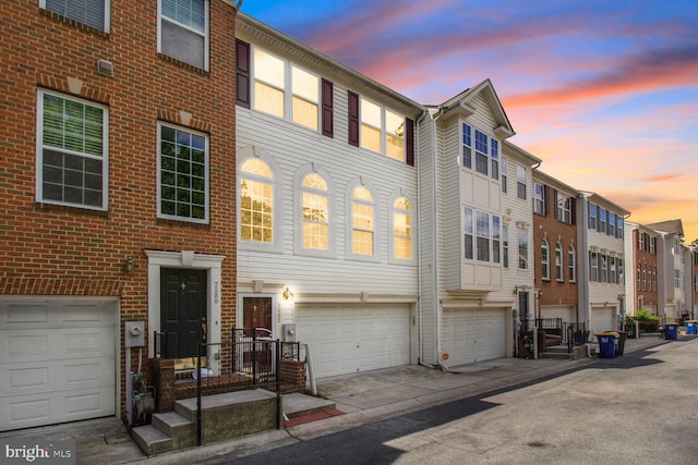view of front of home featuring brick siding, a residential view, and an attached garage