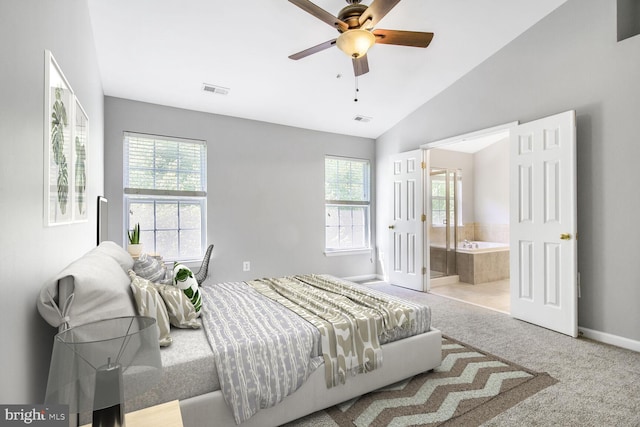 carpeted bedroom featuring multiple windows, baseboards, lofted ceiling, ensuite bath, and ceiling fan