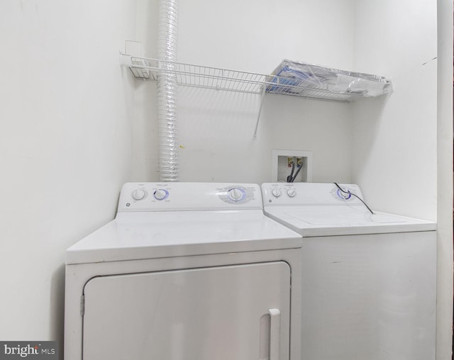 clothes washing area featuring washing machine and clothes dryer
