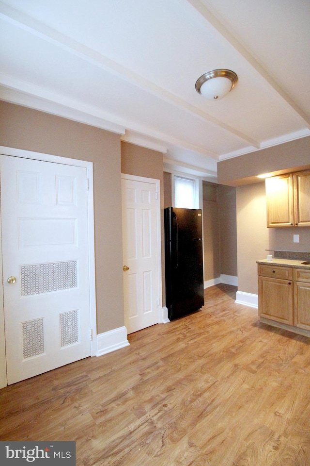 unfurnished living room with light wood-style floors and baseboards