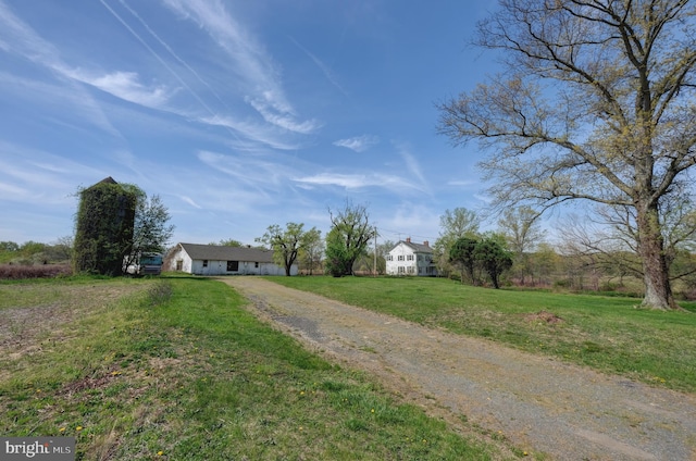 ranch-style home with driveway and a front lawn