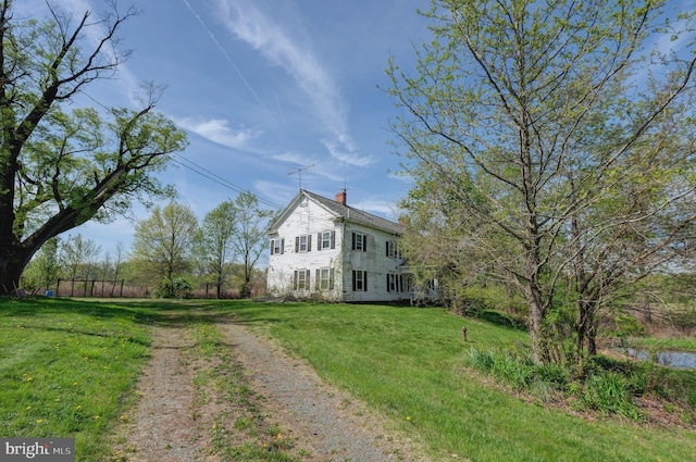 view of front of house featuring a chimney