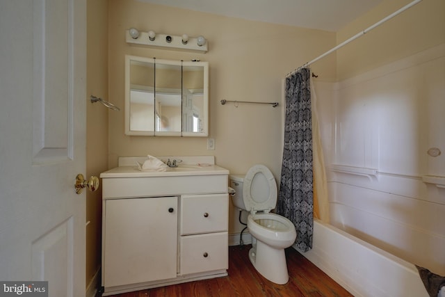 full bathroom with wood finished floors, toilet, vanity, and shower / tub combo