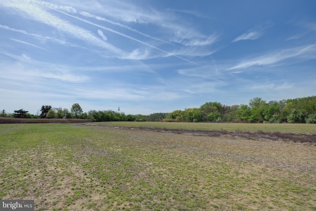 view of grassy yard with a view of countryside