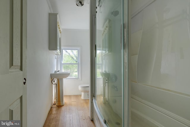 full bathroom with a shower with shower door, toilet, and hardwood / wood-style flooring