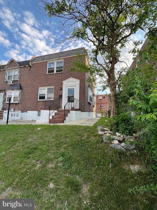 1128 Elbridge St, Philadelphia, PA 19111 - rear view of house with a lawn, brick siding, and cooling unit