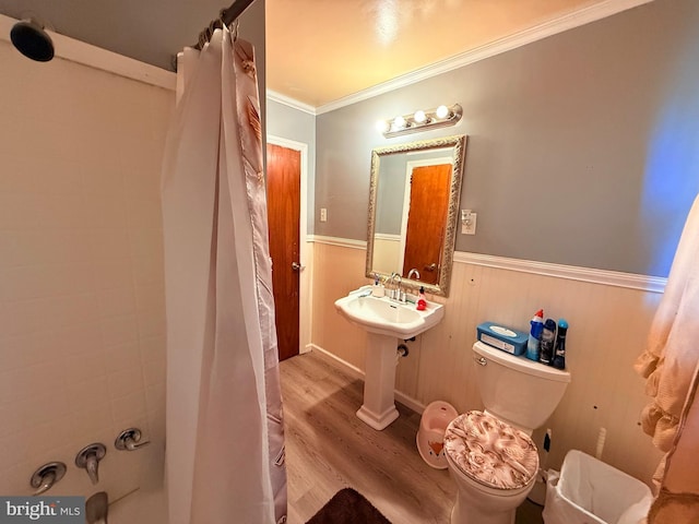 418 N 8th St, Vineland, NJ 08360 - bathroom with wood finished floors, wainscoting, toilet, and ornamental molding