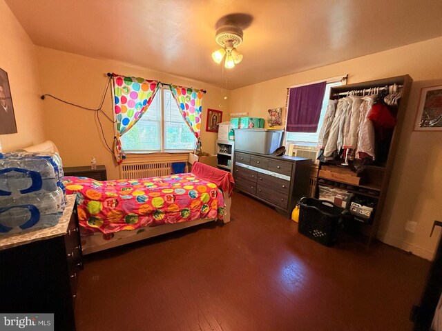 418 N 8th St, Vineland, NJ 08360 - bedroom featuring radiator heating unit and dark wood-type flooring