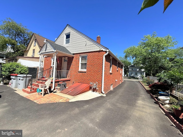 418 N 8th St, Vineland, NJ 08360 - bungalow with a chimney and brick siding