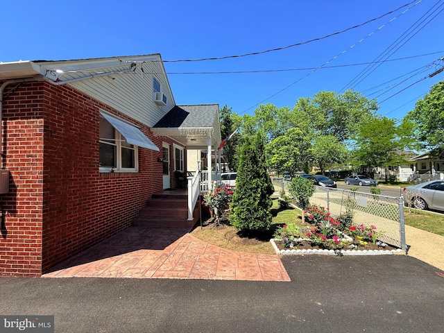 418 N 8th St, Vineland, NJ 08360 - view of home's exterior featuring brick siding and fence