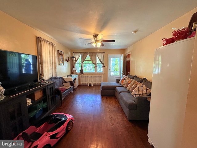 418 N 8th St, Vineland, NJ 08360 - living area with radiator, dark wood-style flooring, and a ceiling fan