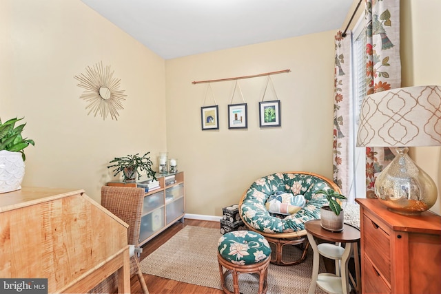 living area featuring wood finished floors and baseboards