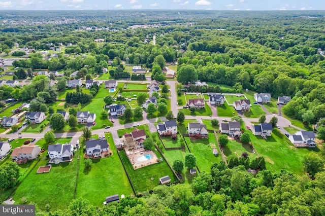 aerial perspective of suburban area with a forest