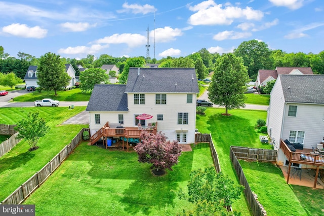back of property featuring a wooden deck, roof with shingles, and a residential view