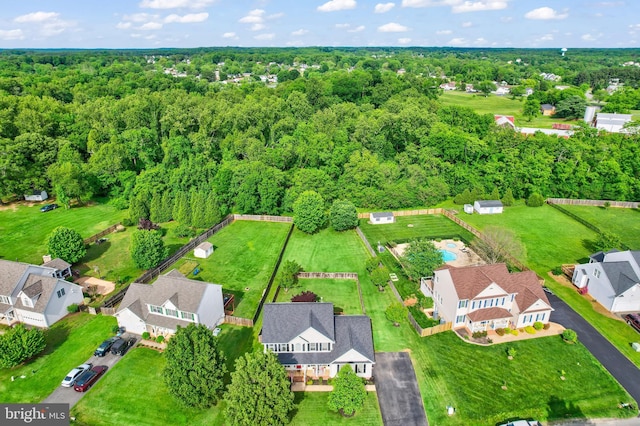 aerial perspective of suburban area with a heavily wooded area