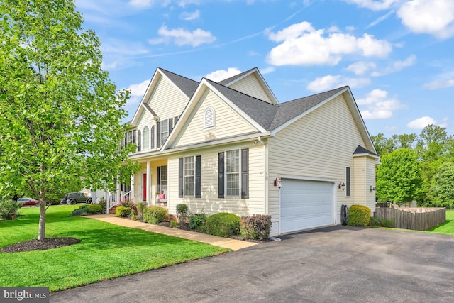 view of front facade featuring asphalt driveway, a garage, and a shingled roof