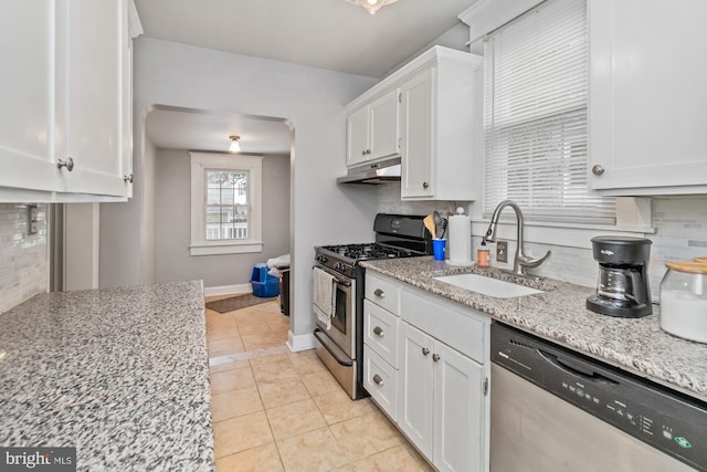 5100 Eugene Ave, Baltimore, MD 21206 - kitchen with appliances with stainless steel finishes, a sink, under cabinet range hood, white cabinets, and tasteful backsplash