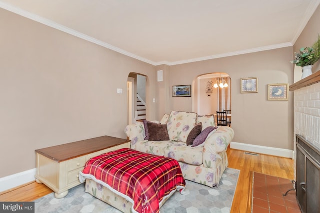5100 Eugene Ave, Baltimore, MD 21206 - living room featuring arched walkways, light wood-style floors, crown molding, baseboards, and stairs