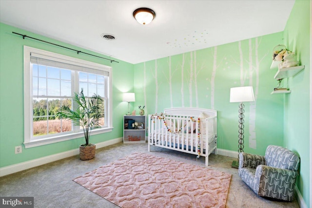 bedroom featuring carpet, baseboards, and a crib