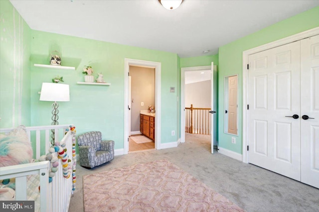 bedroom with light colored carpet, baseboards, and a closet
