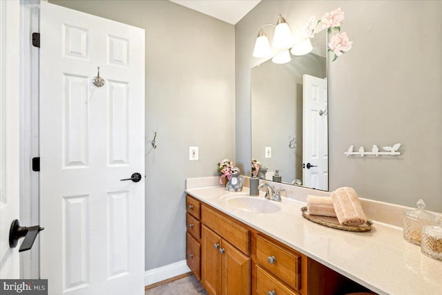 bathroom with vanity and baseboards