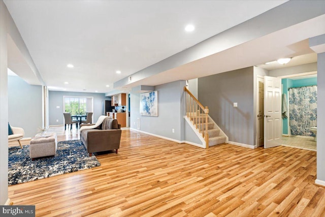 living area with wood finished floors, stairway, baseboards, and recessed lighting