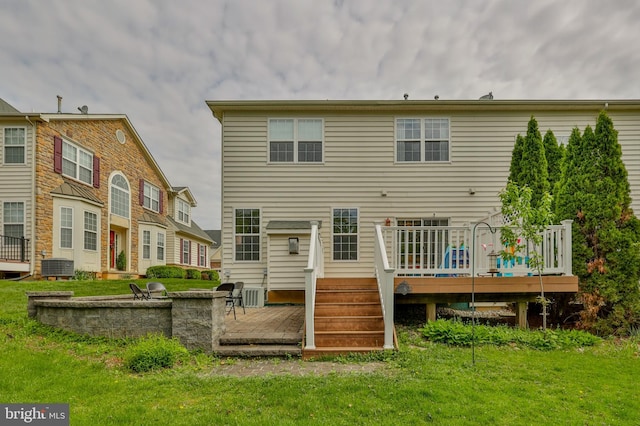 back of house with a deck, central air condition unit, and a lawn