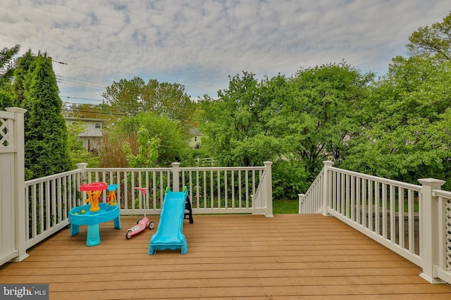 wooden terrace with view of wooded area