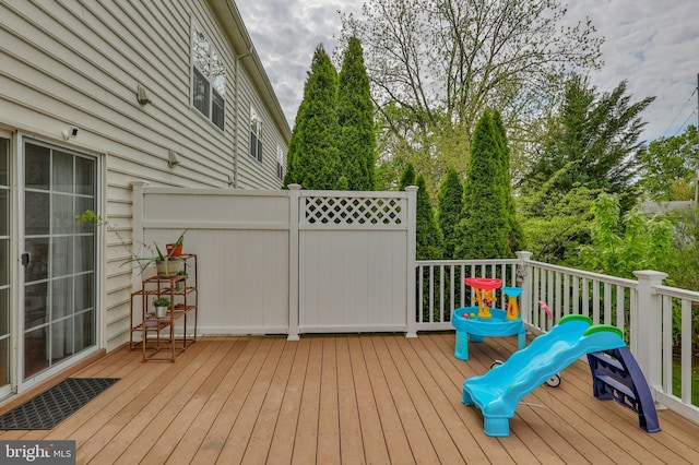 wooden terrace with view of wooded area