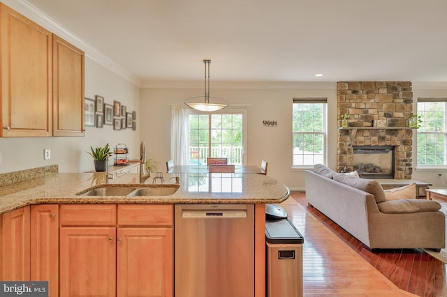 kitchen with dishwasher, open floor plan, light wood-type flooring, light stone counters, and crown molding