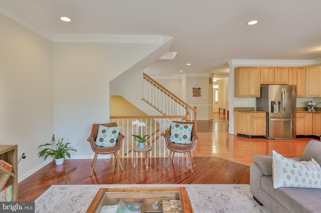 living room featuring ornamental molding, light wood-type flooring, baseboards, stairway, and recessed lighting