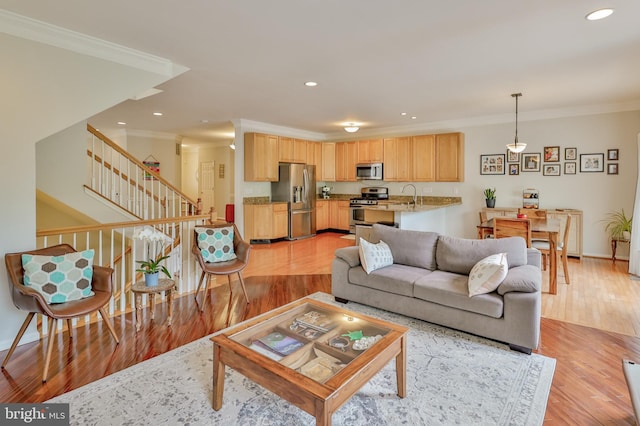living room with ornamental molding, light wood-type flooring, stairs, recessed lighting, and baseboards