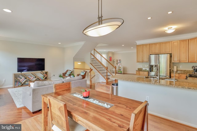 dining room featuring ornamental molding, stairway, light wood-style floors, recessed lighting, and baseboards