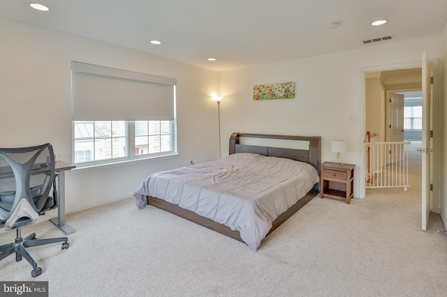carpeted bedroom with multiple windows and recessed lighting