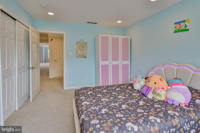 carpeted bedroom featuring a closet and recessed lighting