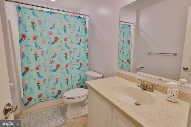 bathroom featuring tile patterned flooring, toilet, and vanity