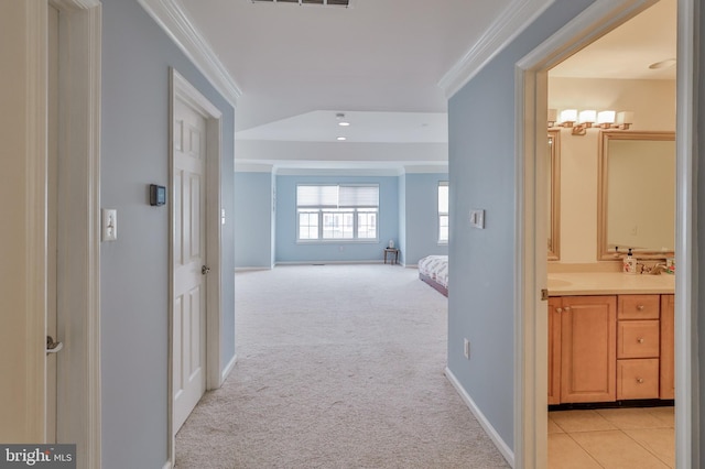 corridor with ornamental molding, light colored carpet, baseboards, and recessed lighting
