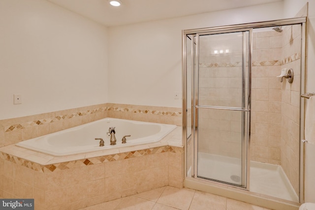 bathroom with tile patterned floors, a shower stall, a bath, and recessed lighting