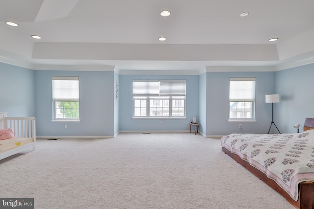 bedroom with a raised ceiling, carpet flooring, baseboards, recessed lighting, and ornamental molding